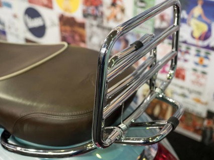 Brown motorbike seat with chrome luggage rack in front of colourful wall, dortmund, deutchland