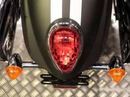 Red tail light with black stripes and orange indicators on metal base, dortmund, deutchland
