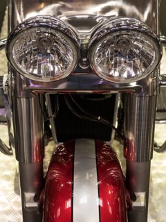 Front view of a motorbike with two round chrome headlights and a red accent colour, dortmund,