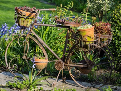 Decorative iron bicycle in the garden, decorated with flower pots and plants, borken, münsterland,