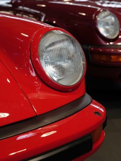 Red Porsche in focus, emphasises the front and headlights, shows classic style, Cologne, Germany