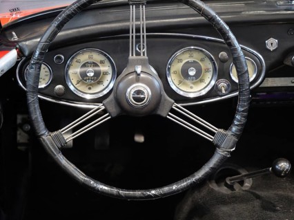 A stylish steering wheel in a classic car, featuring a retro feel and classic instruments, Cologne,