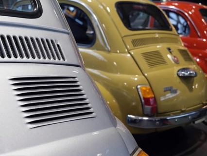 Close-up of colourfully painted vintage cars parked next to each other, creating a nostalgic