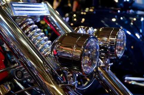 Two shining chrome headlights on a motorbike with blurred background, dortmund, germany