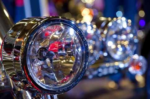 Shiny chrome headlights of a motorbike, surrounded by light reflections, dortmund, germany