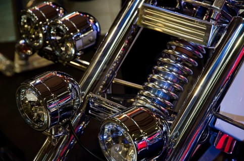 Front view of a motorbike with several shiny chrome headlights and suspension fork, dortmund,