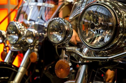 Several motorbikes with striking chrome headlights in a row, dortmund, germany