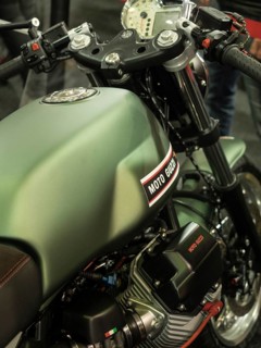 Green Moto Guzzi motorbike tank with technical details and accessories, dortmund, germany
