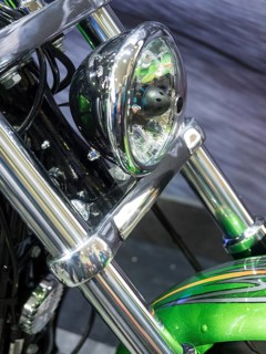 Motorbike headlight with green details and shiny chrome, dortmund, germany