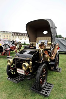 Black and gold classic car with nostalgic retro style, presented at a car exhibition, Retro