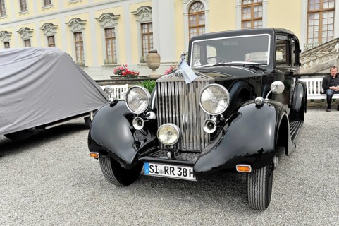 Shiny black classic car in limousine style in front of a historic building, Retro Classics meets