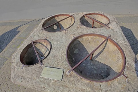 Historic grain stone from 1525, calibration measure for grain, four semicircular holes for