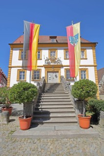 Baroque town hall built in 1739 with German national flag and town flag, open staircase, entrance,