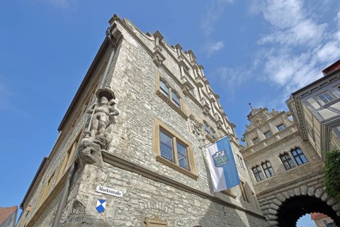 Renaissance town hall built in 1581 with statue of St George and Main Gate, town flag, town gate,