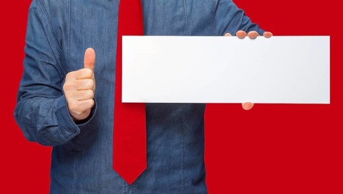 Male person holding a white blank sign in red back