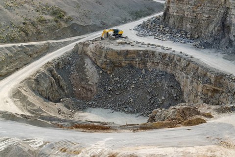 Yellow stone pit digger in stony ambiance
