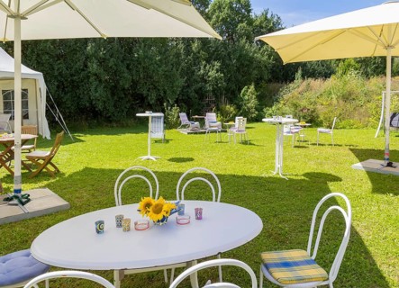 Sunny illuminated idyllic scenery showing a garden prepared for party