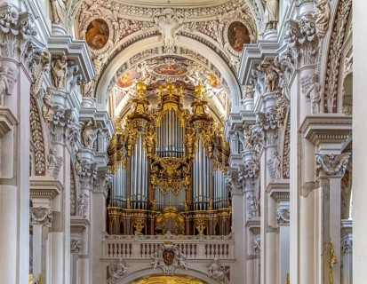 Frontal shot of a rich ornamented church organ