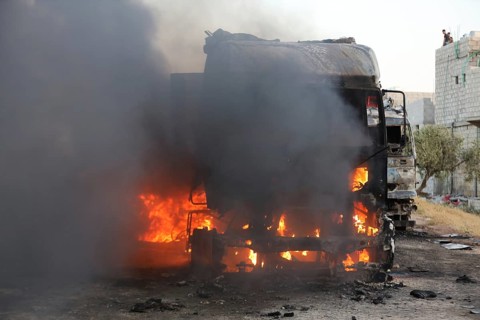 Burned trucks are seen in the opposition-held city of Azaz following shelling by forces loyal to