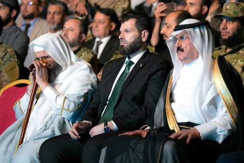 Officials of the new Syrian government take part in a public celebration following the fall of