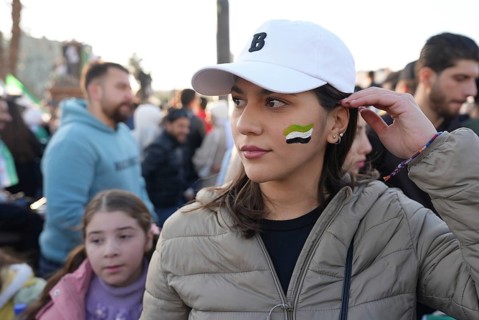Thousands of Syrians take to public squares and main streets waving the revolutionary flag and