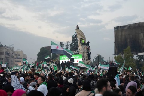 Thousands of Syrians take to public squares and main streets waving the revolutionary flag and