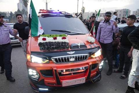 Thousands of Syrians take to public squares and main streets waving the revolutionary flag and