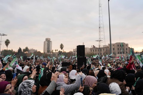 Thousands of Syrians take to public squares and main streets waving the revolutionary flag and