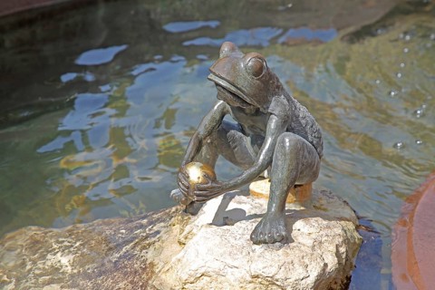 Frog King with golden ball by the water, sculpture, fairytale figure, fairytale fountain, market