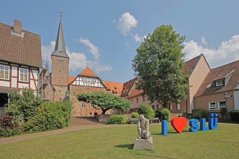 Heart sign as a symbol of solidarity and love for the city of SLÜ, monument to medieval humanist,
