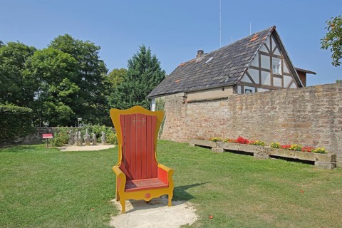 Red golden throne in the inner courtyard, garden, museum, Brothers Grimm House, Steinau an der