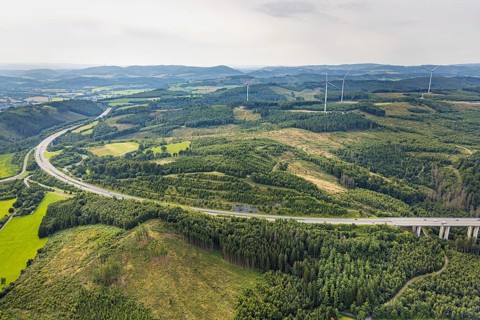 Aerial view, forest area with forest damage and wind turbines, motorway A46 with Freienohl