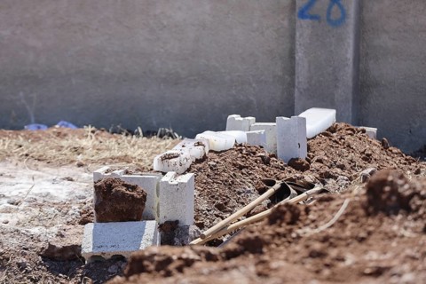 View shows a grave covered with blocks of snow in a cemetery. Azaz, Syria. July 3, 2024, Aleppo,