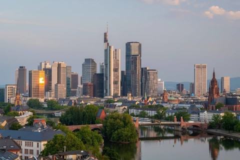 Frankfurt City Skyline, Residential Buildings, Bridges and Main River at Sunrise. Aerial View.