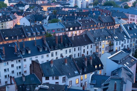 Old Residential Buildings in Frankfurt City at Evening Twilight with Illuminated Windows. Aerial
