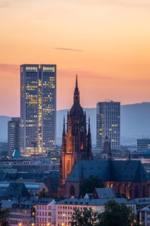 Illuminated Frankfurt Cathedral, Residential Buildings and City at Evening Twilight. Aerial View.
