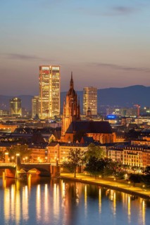 Illuminated Frankfurt Cathedral, Residential Buildings, City and Main River at Night. Aerial View.