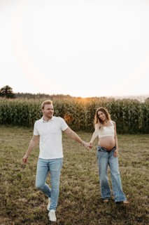 Pregnant young woman walks with her partner
