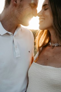 Young couple in love, nose to nose in front of the sunset