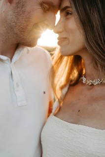 Young couple in love, forehead to forehead in front of the sunset