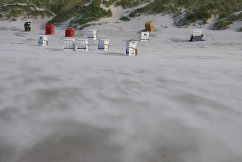 A strong storm whistles across the desert-like western beach of the North Frisian island of Amrum,