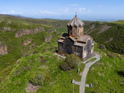Church on a green hill with a view of a mountain landscape, aerial view, Church of the Mother of