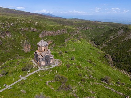 Small church on a green mountain overlooking a valley, aerial view, Church of the Mother of God,