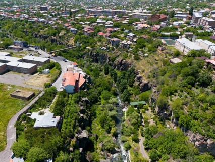 Urban view with a river surrounded by houses and a rocky gorge, aerial view, Kassagh River,