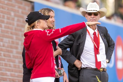 Tiffany Foster, Amy Millar and Chef d'Equipe, Ian Millar from Team Canada watch Susan Horn compete
