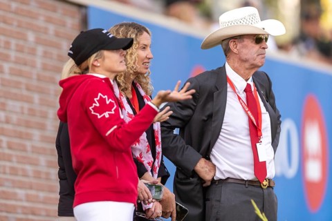 Tiffany Foster, Amy Millar and Chef d'Equipe, Ian Millar from Team Canada watch Susan Horn compete