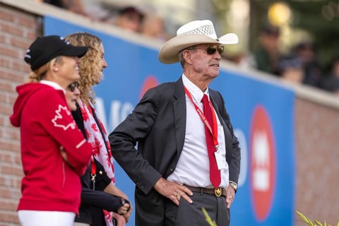 Tiffany Foster, Amy Millar and Chef d'Equipe, Ian Millar from Team Canada watch Susan Horn compete