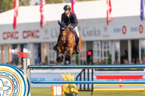 Ben Maher of England, riding Enjeu De Grisien, competes in the first round of the 2025 BMO Nations