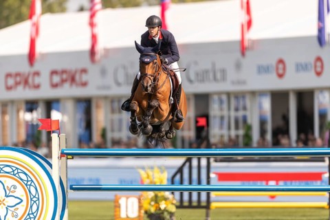 Ben Maher of England, riding Enjeu De Grisien, competes in the first round of the 2025 BMO Nations