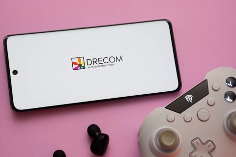 Dhaka, Bangladesh- 13 Sep 2025: A close-up of a gamepad with the Drecom seen on smartphone